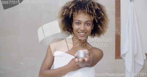 Image of Cosmetic Cream Container In Woman Hand