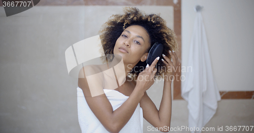 Image of Woman Fixing Hair In The Morning