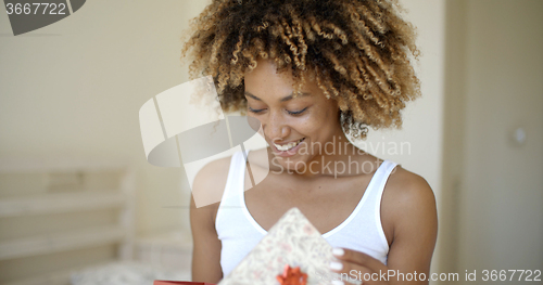 Image of Happy Young Woman Open Gift Box In Bedroom