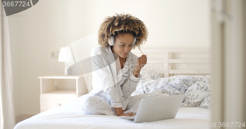 Image of Cute Black Girl Listening To Headphones