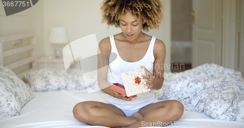 Image of Happy Young Woman Open Gift Box In Bedroom
