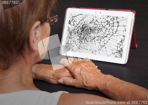 Image of Senior lady with tablet, cracked screen