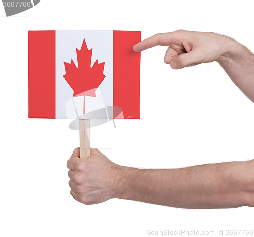 Image of Hand holding small card - Flag of Canada