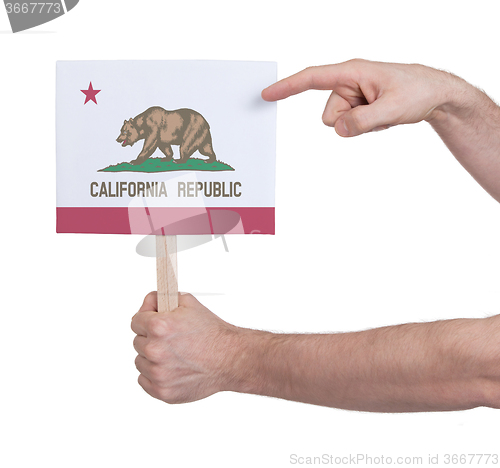 Image of Hand holding small card - Flag of California