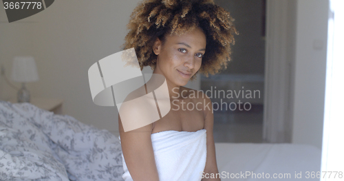 Image of Happy Woman Sits In Bed And Smiling