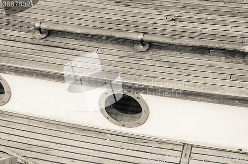 Image of Close up of a deck of old sailing ship, sepia