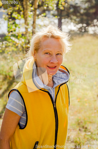 Image of Portrait of a middle-aged woman in a park on a sunny day