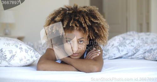 Image of Cute woman lying on bed at home in bedroom