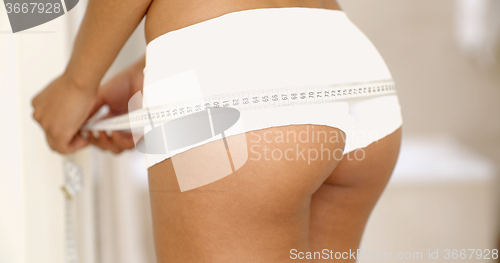 Image of Young Woman Measures To Itself Ass