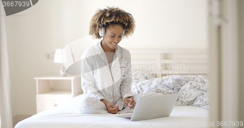 Image of Girl With Headphones Listening To The Music