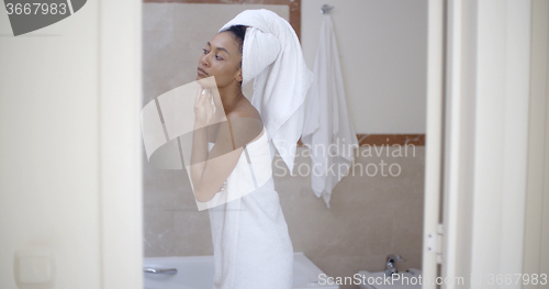 Image of Woman With Towel On Head In The Bathroom