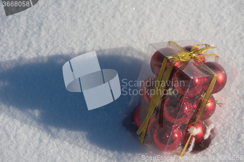Image of christmas ball in box on fresh  snow