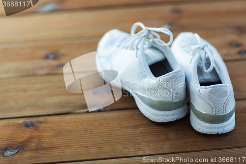 Image of close up of sneakers on wooden floor