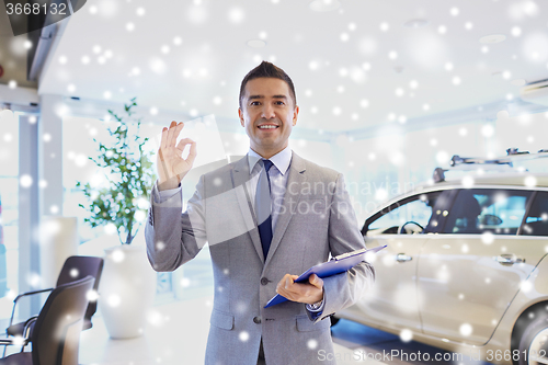 Image of happy man at auto show or car salon