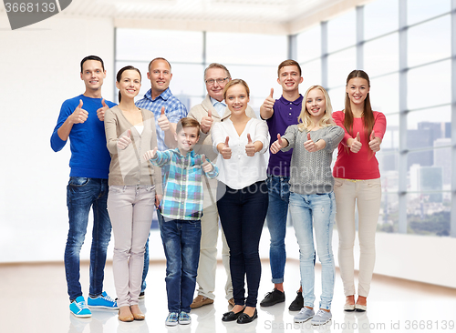 Image of group of smiling people showing thumbs up