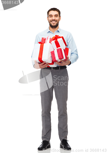 Image of happy young man holding gift boxes