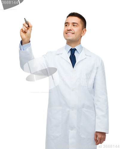 Image of smiling male doctor writing something with marker