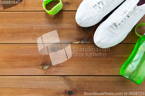 Image of close up of sneakers, bracelet and water bottle