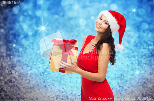 Image of beautiful sexy woman in santa hat with gift box