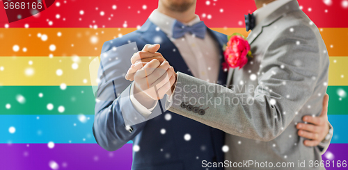 Image of close up of happy male gay couple dancing