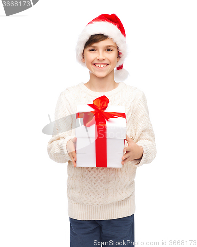 Image of smiling happy boy in santa hat with gift box