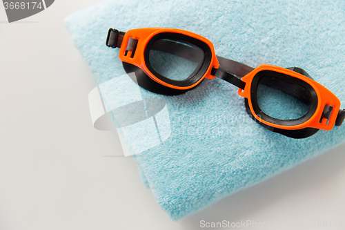 Image of close up of swimming goggles and towel