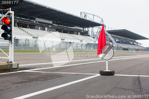 Image of red traffic lights and road sign on race track