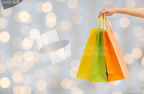 Image of close up of hand holding shopping bags