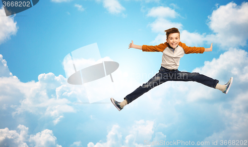 Image of happy smiling boy jumping in air