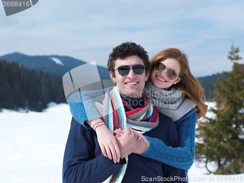 Image of happy young couple having fun on fresh show on winter vacation