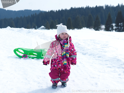 Image of little baby girl have fun on fresh snow