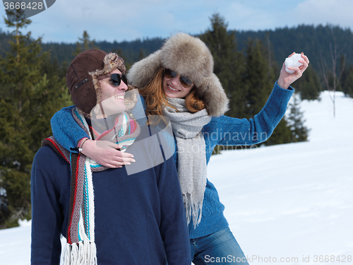 Image of happy young couple having fun on fresh show on winter vacation