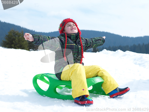 Image of happy young boy have fun on winter vacatioin on fresh snow