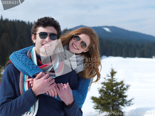 Image of happy young couple having fun on fresh show on winter vacation