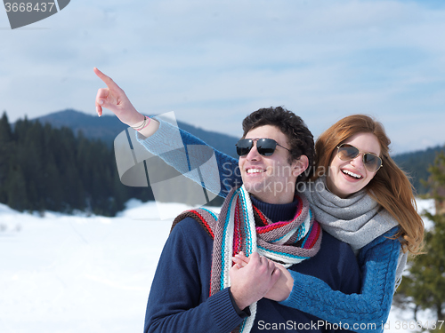 Image of happy young couple having fun on fresh show on winter vacation