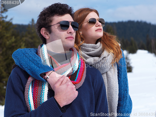 Image of happy young couple having fun on fresh show on winter vacation