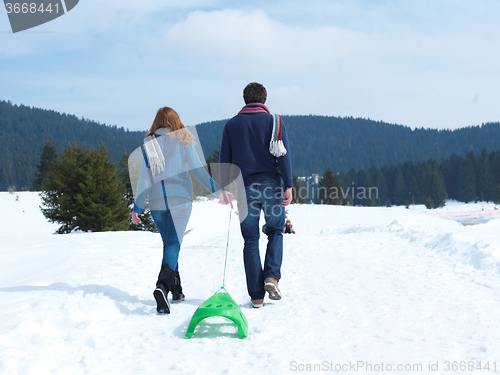 Image of happy young couple having fun on fresh show on winter vacation