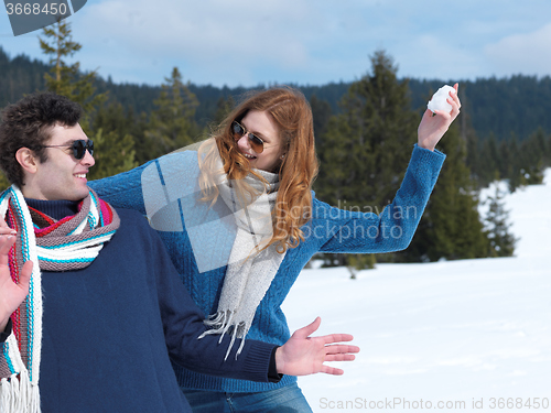 Image of happy young couple having fun on fresh show on winter vacation