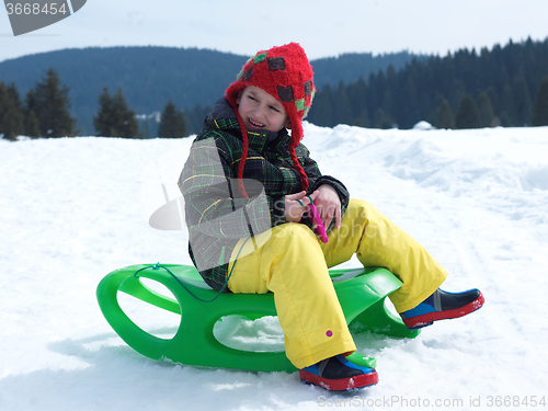 Image of happy young boy have fun on winter vacatioin on fresh snow