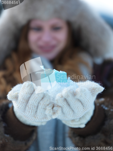 Image of portrait of  girl with gift at winter scene and snow in backgron