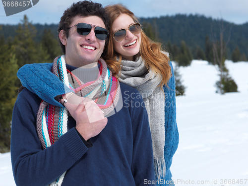 Image of happy young couple having fun on fresh show on winter vacation