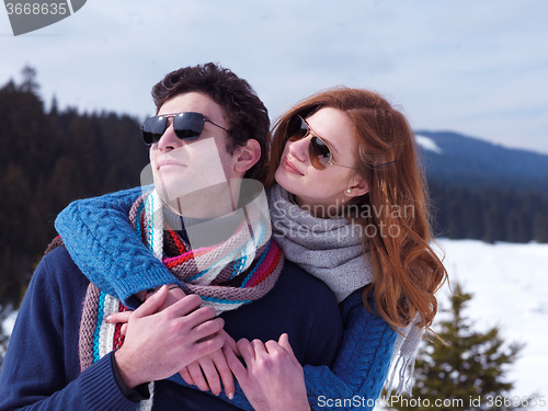 Image of happy young couple having fun on fresh show on winter vacation