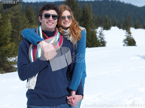 Image of happy young couple having fun on fresh show on winter vacation