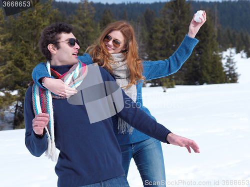 Image of happy young couple having fun on fresh show on winter vacation