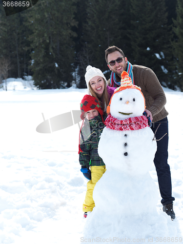 Image of happy family making snowman