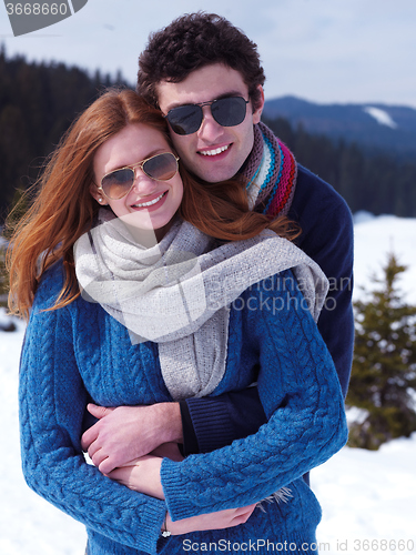 Image of happy young couple having fun on fresh show on winter vacation