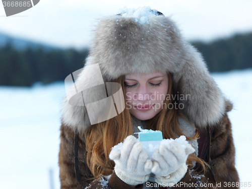 Image of portrait of  girl with gift at winter scene and snow in backgron