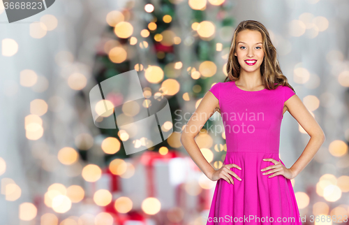 Image of happy woman or teen girl over christmas lights