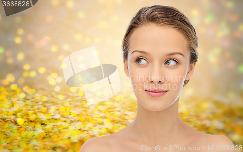 Image of smiling young woman face and shoulders