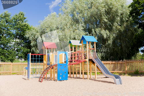 Image of climbing frame with slide on playground at summer